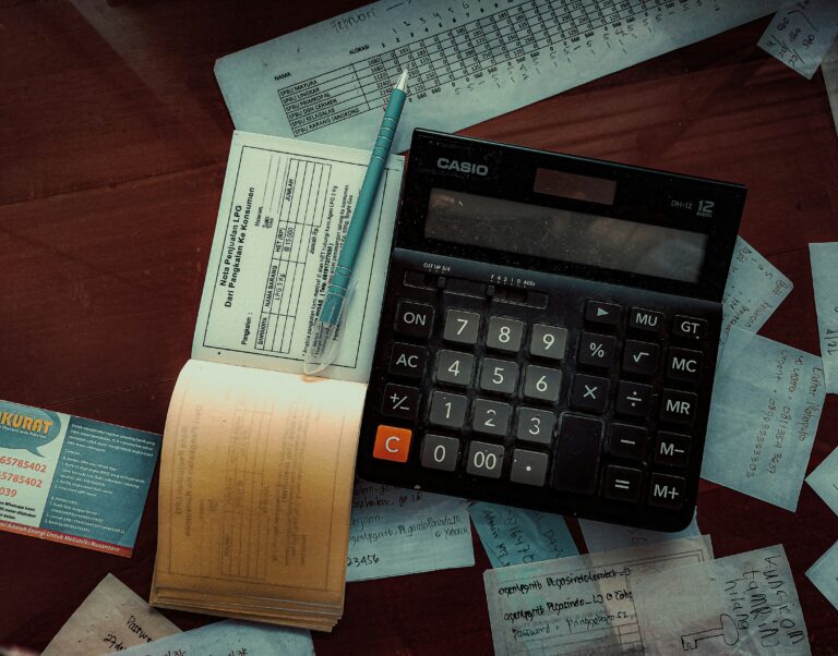 Calculator on wooden desk for bank reconciliations property management workflow