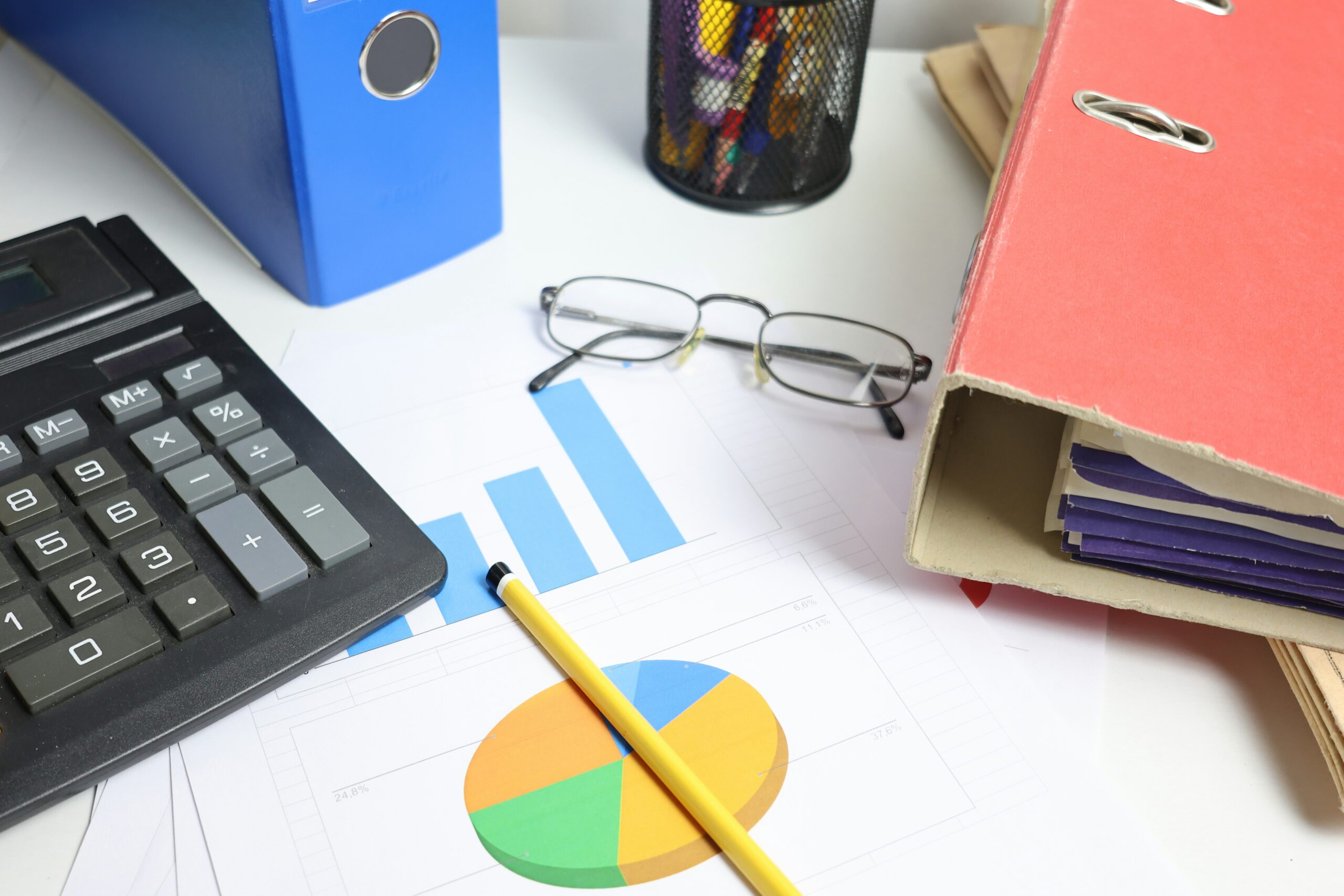 Desk with calculator and charts representing commercial property management accounting software