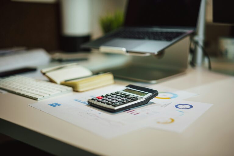 Calculator and laptop representing HOA accounting software