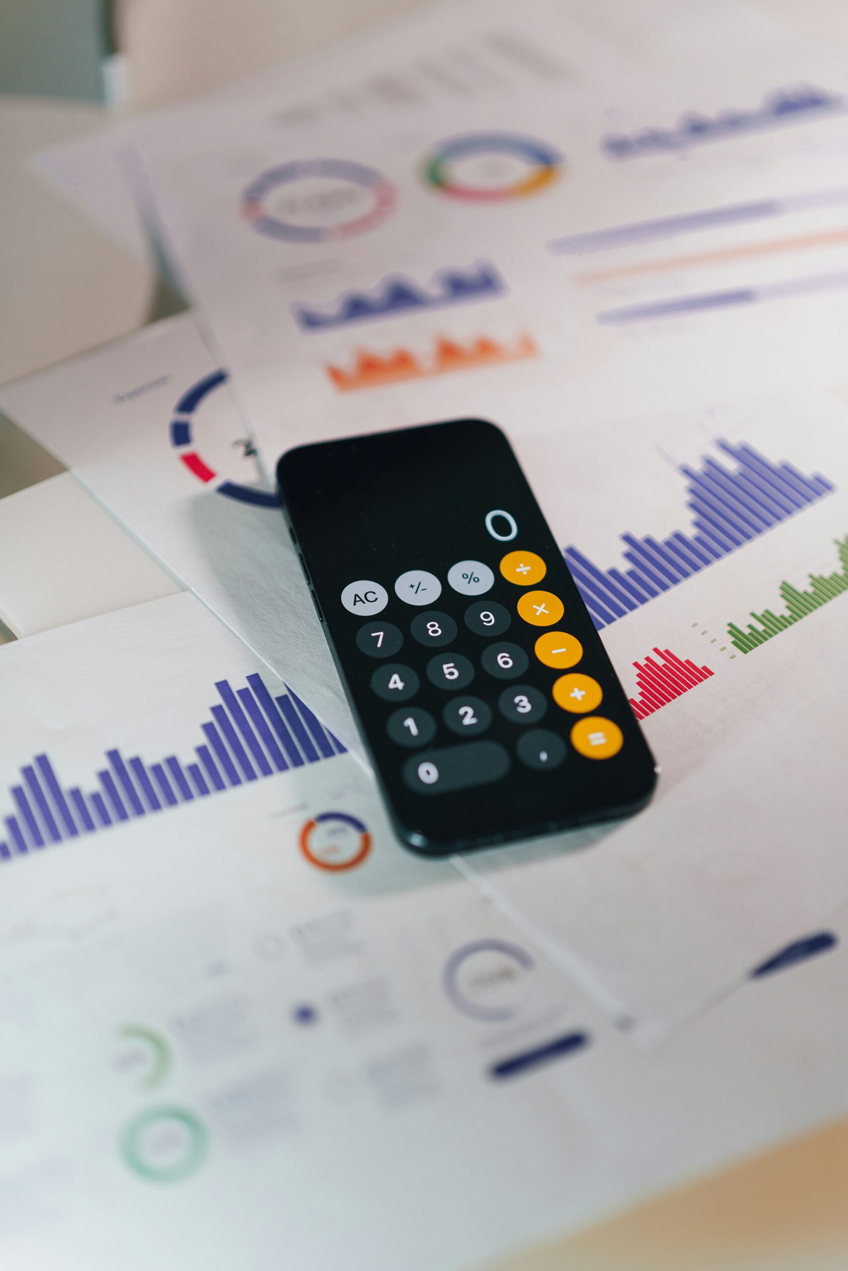 Calculator over financial papers representing trust accounting QuickBooks property management