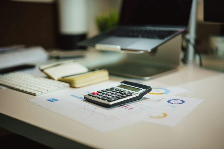 Calculator and laptop for rental property bonus depreciation planning
