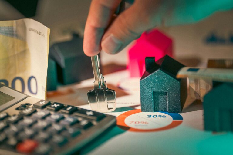 Hand holding a house key representing vacation rental management